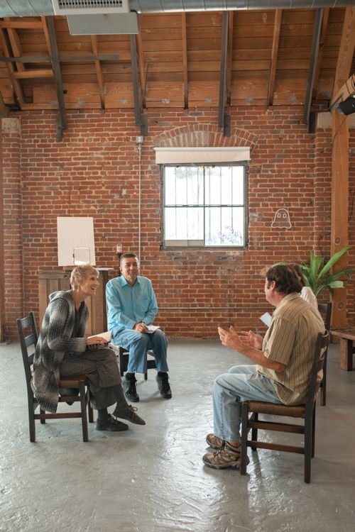 Adults listening and sharing in a facilitated group discussion