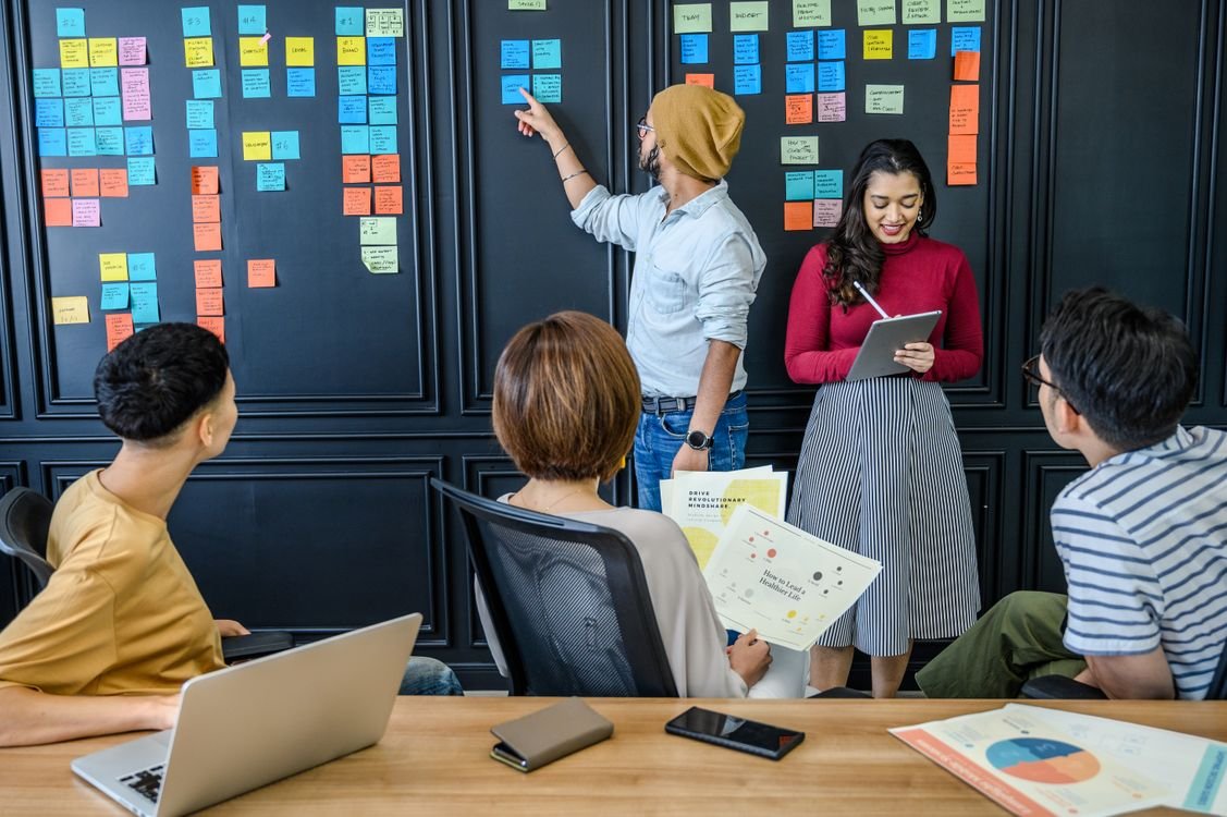 Young adults collaborating with sticky notes during a group activity